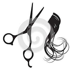 Hairdressing scissors and a lock of curly hair photo