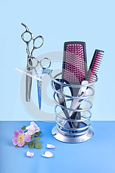 Hairdressing set of scissors and brushes on a blue background photo