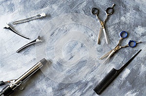 Hairdressing supplies: scissors, comb, hair tongs and clips.