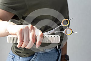 Hairdressing tools in the girl`s hands