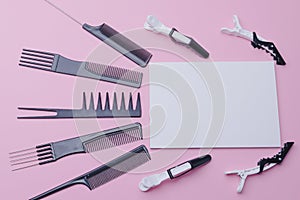 hairdressing tools. on a pink background, a blank sheet of white paper for placing text, advertising.