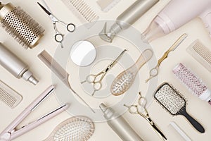 Hairdressing tools and various hairbrushes on cream background top view