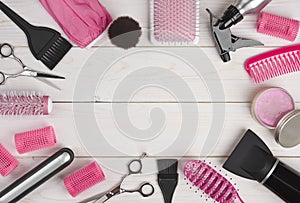 Hairdressing tools on wooden planks background with copyspace in centre