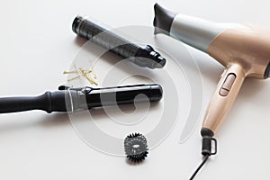 Hairdryer, styler or curling iron and hair spray