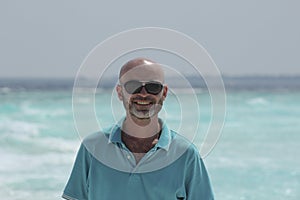 Hairless middle-aged man on the beach