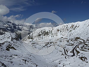 Hairpinned road in snow covered mountains