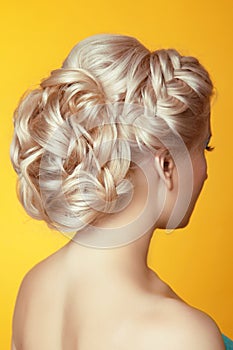 Hairstyle. Beauty Blond girl bride with curly hair styling over