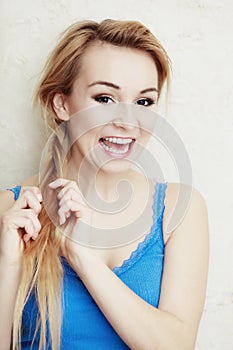 Hairstyle. Blond woman teenage girl plaiting braid hair.