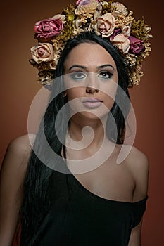 Hairstyle and Make up - beautiful female art portrait with wreath of roses, studio.