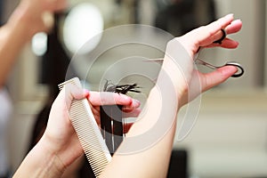 Hairstylist cutting hair woman client in hairdressing beauty salon