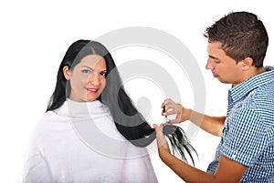 Hairstylist cutting long woman hair photo