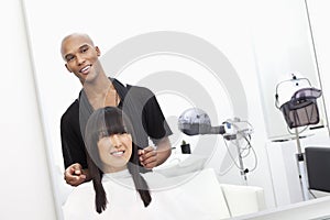 Hairstylist with female customer at beauty salon photo