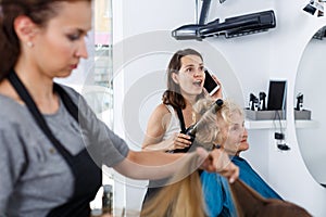 Hairstylist having phone conversation