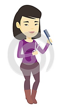 Hairstylist holding comb and scissors in hands.