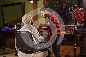 Hairstylist serving client at barber shop. Personal stylist barber. retro and vintage. Designing haircut. barber tools
