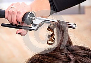 Hairstylist using a curling iron or tongs