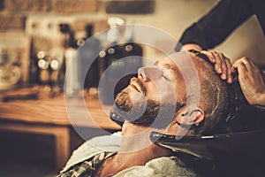 Hairstylist washing client's hair photo