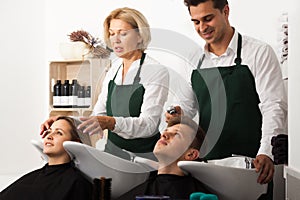 Hairstylistss washing the hair of customers at the hairdressing