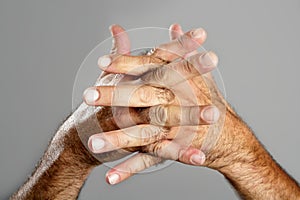 Hairy man hand closeup expression over gray