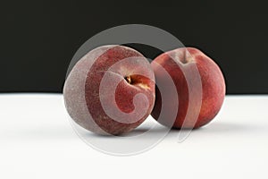 Hairy peaches on a white and black background