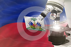 Haiti science development concept - microscope on flag background. Research in pharmaceutical industry or biology 3D illustration