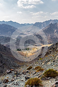 Hajar Mountains and Wadi Ghargur landscape view with transmission towers, UAE