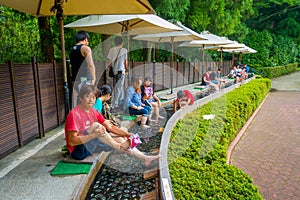 HAKONE, JAPAN - JULY 02, 2017: Unidentified people refresing their foots inside of water at Hakone Open-Air Museum or