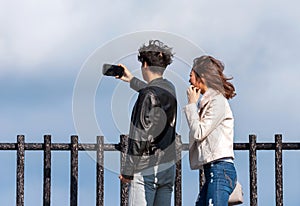 HAKONE, JAPAN - NOVEMBER 5, 2017: Young couple doing selfie on a background of mountains. Copy space for text.