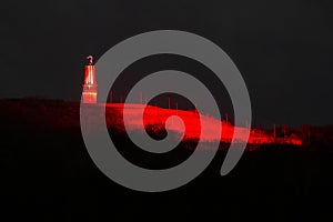 Halde Rheinpreussen, Moers, bathed in ruby red light with mining light