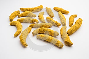 Haldi or Dried Turmeric Roots as a whole on white background