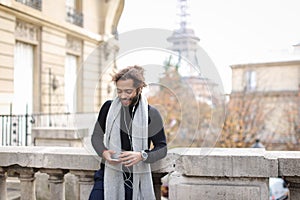 Half African tourist listening to new songs in earphones with sm