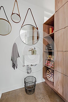 Half bathroom with circular mirrors