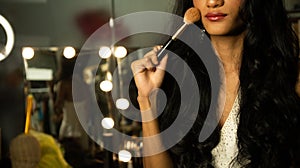 Half body disable person without fingers thumb hand of young adult woman using cosmetic brush lipstick at make up mirror desk.