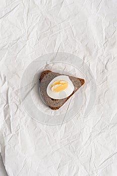 Half boiled egg on a triangular piece of bread