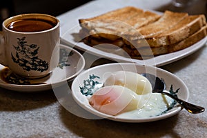 Half boiled eggs, coffee, toast bread, popular Chinese style breakfast in Malaysia
