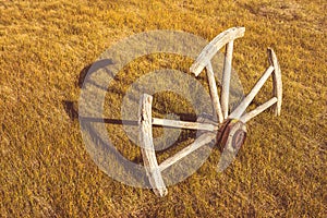 Half Buried Vintage Wagon Wheel in a Field
