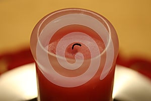 Half-Burned Thick Pink and Red Wax Candle in a Closeup