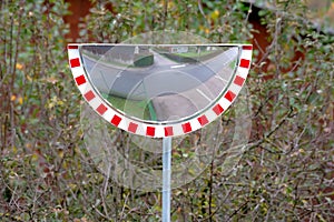 Half circled traffic mirror in a rural area