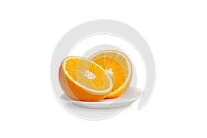 Half cut orange on a saucer isolated on white background