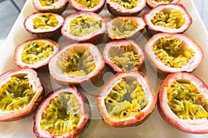 Half cut passion fruits on white plate. Ripe passion fruit isolated on table.