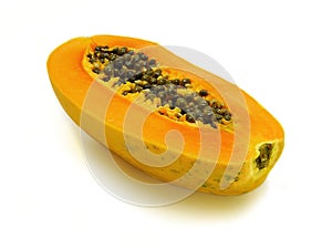 Half cut ripe papaya on white background - close up view.