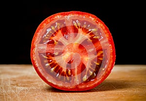 Half Cut Sliced of Fresh Tomato on Wood Table