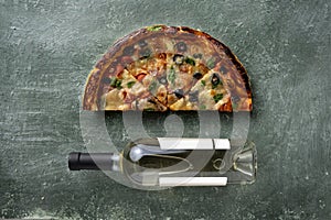 Half a delicious homemade italian pizza on the table, pizza with wine, copy space for your text,