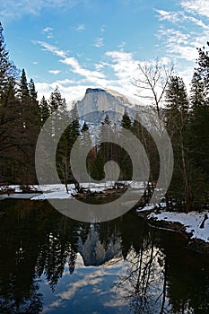 Half Dome reflected in Merced River in Yosemite National Park, California.
