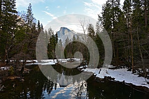 Half Dome reflected in Merced River in Yosemite National Park, California.