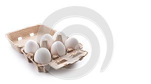Half dozen, six, white eggs in brown carton container with lid o