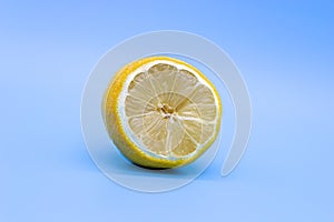Half-Dried yellow lemon on a blue background, close