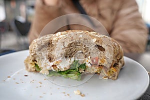 half eaten beef burger on table close up