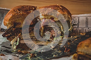 A half-eaten burger on a table in a cafe.