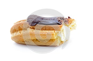 A half-eaten eclair with cream isolated on white background